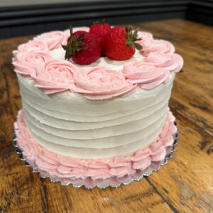 Strawberry Fields Cake (vanilla cake with a layer of fresh strawberries and a layer of strawberry preserves iced in buttercream and trimmed in strawberry icing)